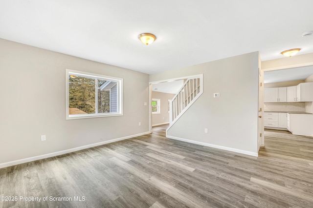 14 Maiden Ln, Susquehanna, PA 18847 - unfurnished living room featuring light wood-type flooring, stairs, and baseboards