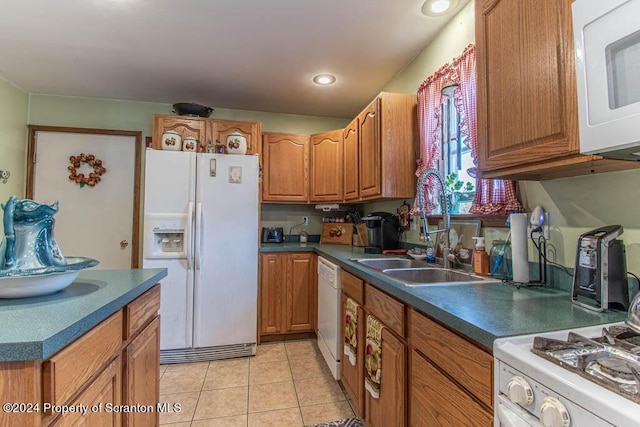 kitchen with sink, light tile patterned floors, and white appliances