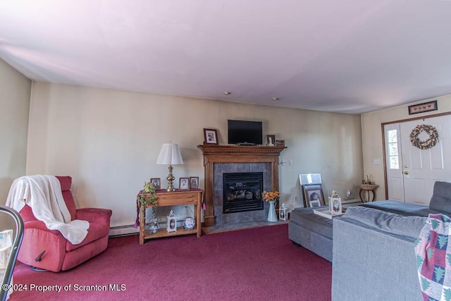 carpeted living room with a baseboard heating unit and a tiled fireplace