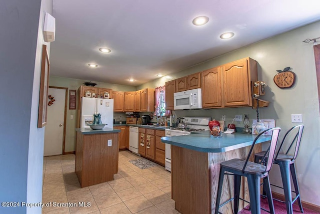 kitchen featuring a kitchen bar, decorative backsplash, white appliances, light tile patterned floors, and a center island