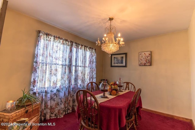 carpeted dining space featuring a notable chandelier