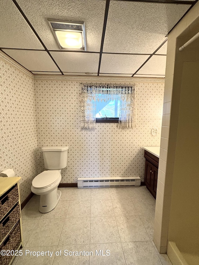 full bathroom with walk in shower, toilet, vanity, a baseboard radiator, and a drop ceiling