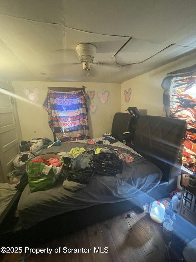 bedroom with hardwood / wood-style flooring and ceiling fan