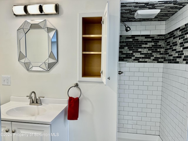 bathroom with vanity and tiled shower