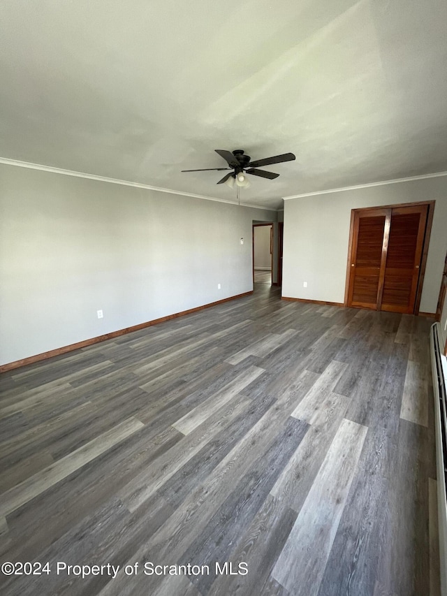 unfurnished bedroom with ceiling fan, crown molding, and dark wood-type flooring