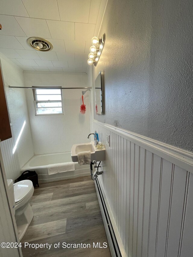 full bathroom featuring shower / bathtub combination, toilet, wood-type flooring, and sink