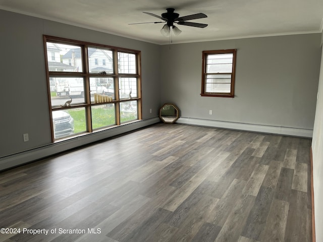 spare room with hardwood / wood-style flooring, a wealth of natural light, and crown molding