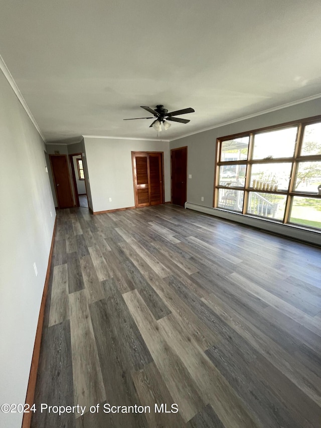 unfurnished living room with dark hardwood / wood-style floors, ceiling fan, ornamental molding, and a baseboard heating unit