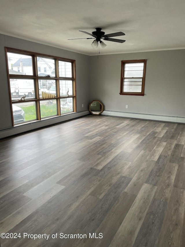 unfurnished room with dark hardwood / wood-style floors, ceiling fan, ornamental molding, and baseboard heating