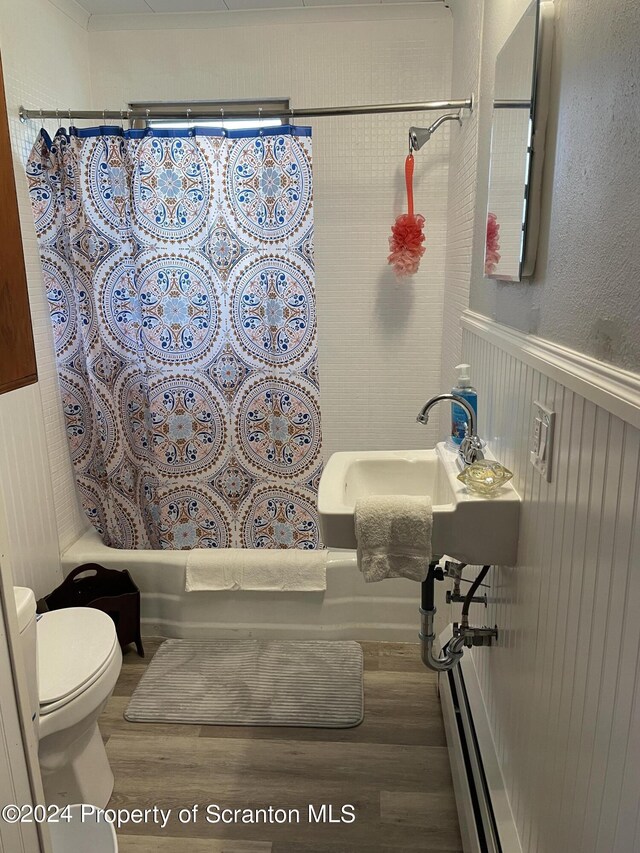 full bathroom with hardwood / wood-style flooring, toilet, sink, and shower / tub combo