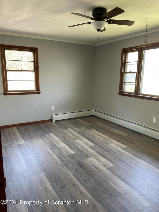 empty room featuring ceiling fan, hardwood / wood-style floors, and ornamental molding