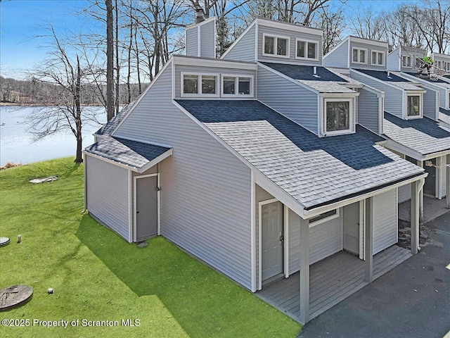134 Laurel Hill Dr Unit 102, Greentown, PA 18426 - view of side of property with a chimney, roof with shingles, a yard, and a water view