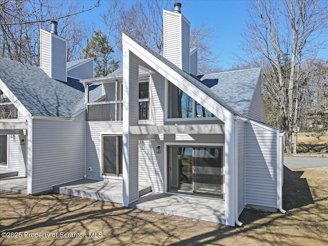 134 Laurel Hill Dr Unit 102, Greentown, PA 18426 - back of house with a chimney, a balcony, a patio area, and a shingled roof