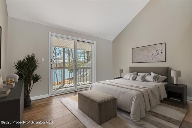 134 Laurel Hill Dr Unit 102, Greentown, PA 18426 - bedroom with hardwood / wood-style floors, access to outside, and high vaulted ceiling