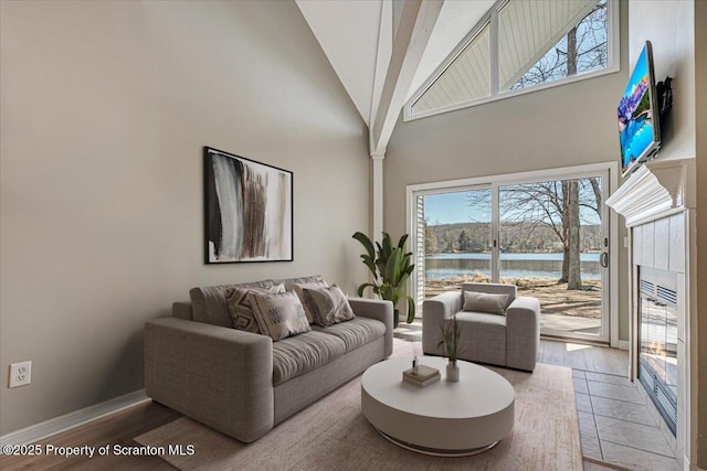 134 Laurel Hill Dr Unit 102, Greentown, PA 18426 - living room with high vaulted ceiling, light wood finished floors, and a tile fireplace