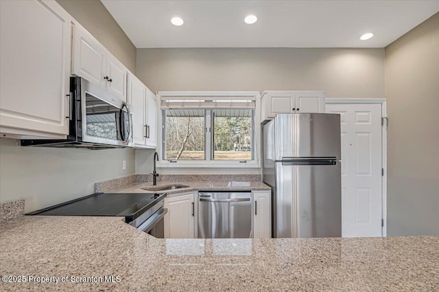 134 Laurel Hill Dr Unit 102, Greentown, PA 18426 - kitchen featuring appliances with stainless steel finishes, white cabinets, light stone countertops, and recessed lighting