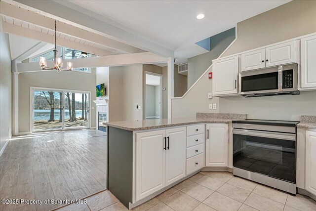 134 Laurel Hill Dr Unit 102, Greentown, PA 18426 - kitchen with appliances with stainless steel finishes, a chandelier, a peninsula, open floor plan, and white cabinets