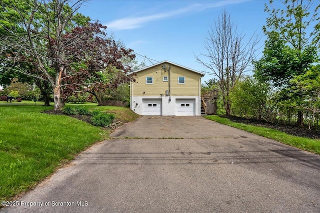 6 Eastview Dr, Scott Twp, PA 18411 - view of side of property featuring stairway, a garage, driveway, and a yard