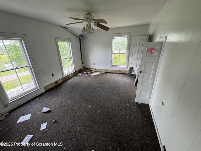 11269 State Route 29, Montrose, PA 18801 - unfurnished living room with carpet floors, a ceiling fan, and wooden walls