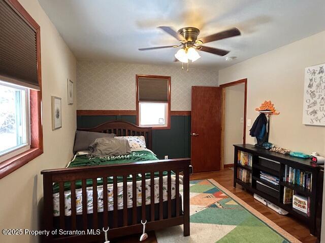 bedroom featuring ceiling fan and dark hardwood / wood-style flooring