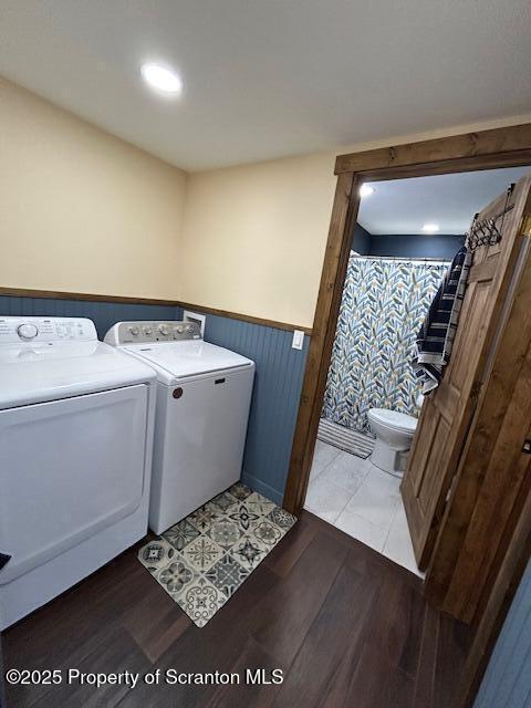 laundry room featuring washer and clothes dryer and light wood-type flooring