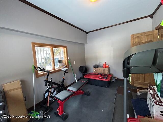 workout area featuring crown molding