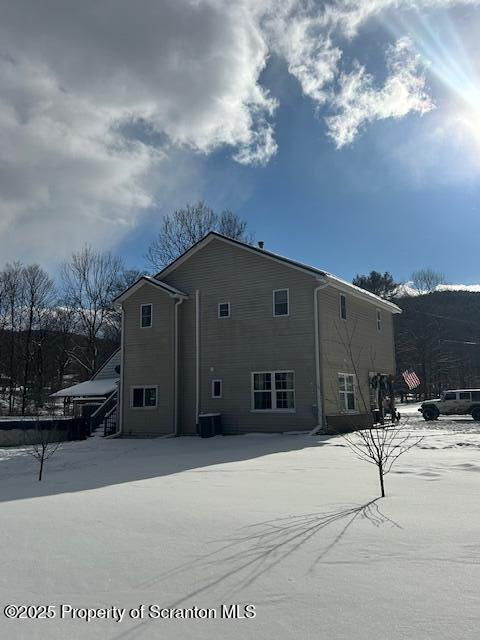 rear view of property with central AC