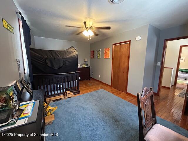 bedroom featuring ceiling fan and light hardwood / wood-style floors