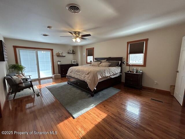 bedroom featuring dark wood-type flooring, access to outside, and ceiling fan