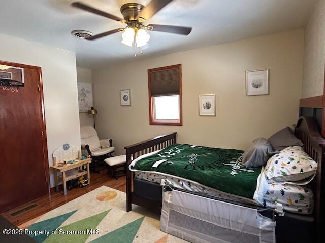 bedroom with light hardwood / wood-style flooring and ceiling fan