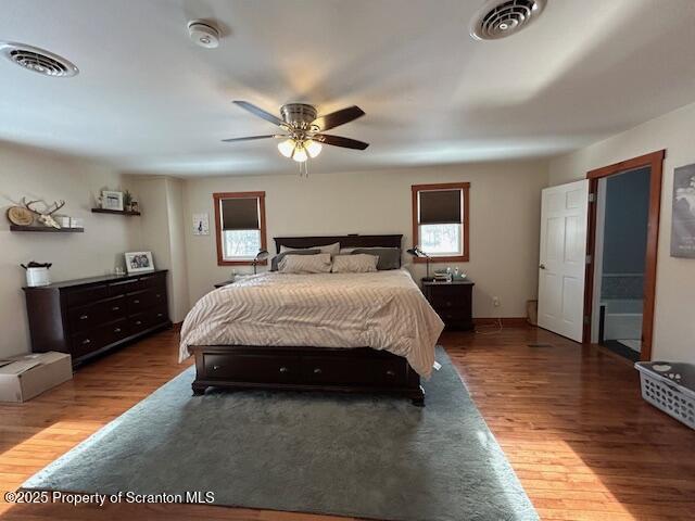 bedroom with dark wood-type flooring and ceiling fan