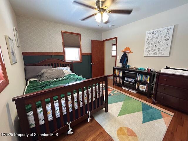 bedroom featuring dark wood-type flooring and ceiling fan