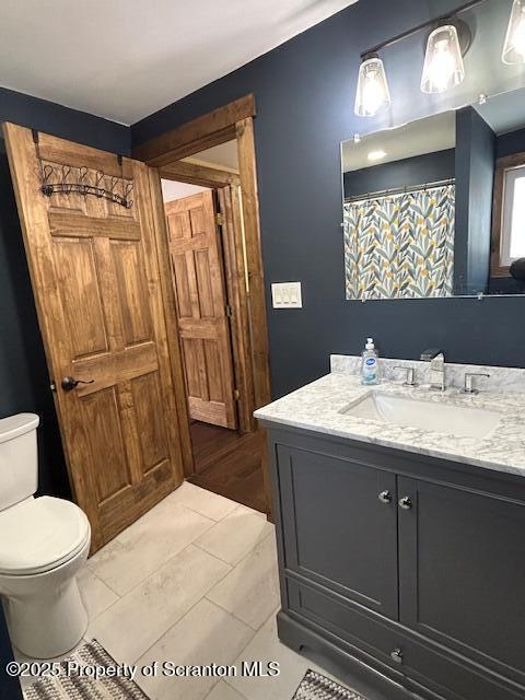 bathroom featuring vanity and toilet