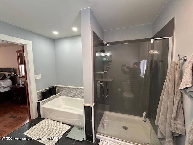 bathroom featuring tile patterned floors and separate shower and tub