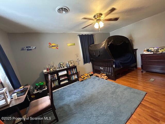 bedroom featuring wood-type flooring and ceiling fan