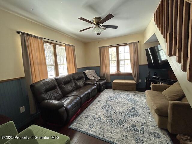 living room featuring ceiling fan and hardwood / wood-style floors