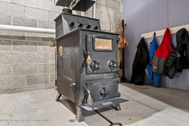 details featuring a wood stove and concrete floors