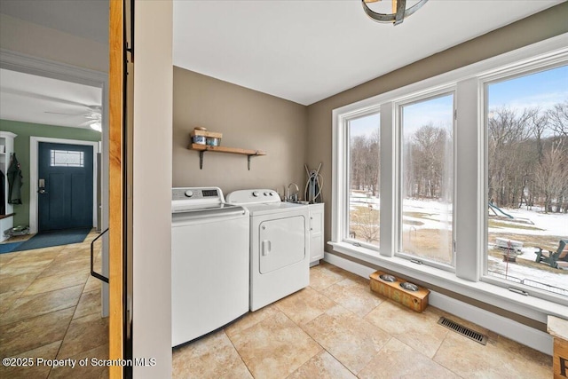 laundry room featuring a healthy amount of sunlight and washing machine and dryer