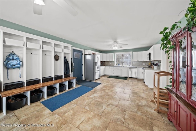 mudroom featuring ceiling fan and sink