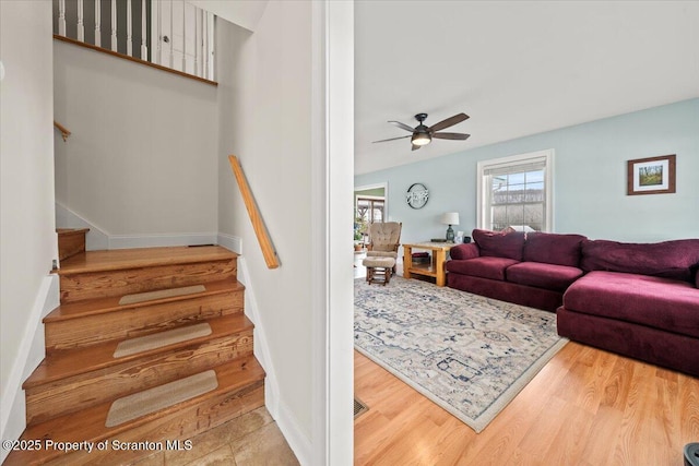 living room featuring hardwood / wood-style floors and ceiling fan