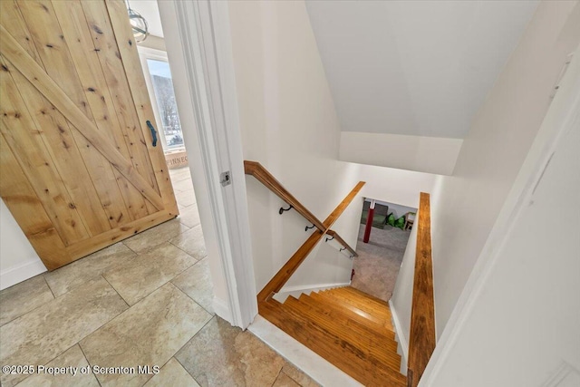 stairway with vaulted ceiling