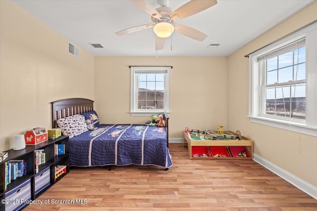 bedroom with light wood-type flooring and ceiling fan