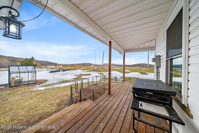 deck with an outbuilding and a mountain view