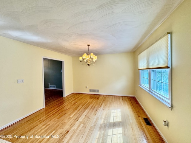 13 Forest Glen Dr, Scranton, PA 18504 - spare room with a chandelier and light wood finished floors