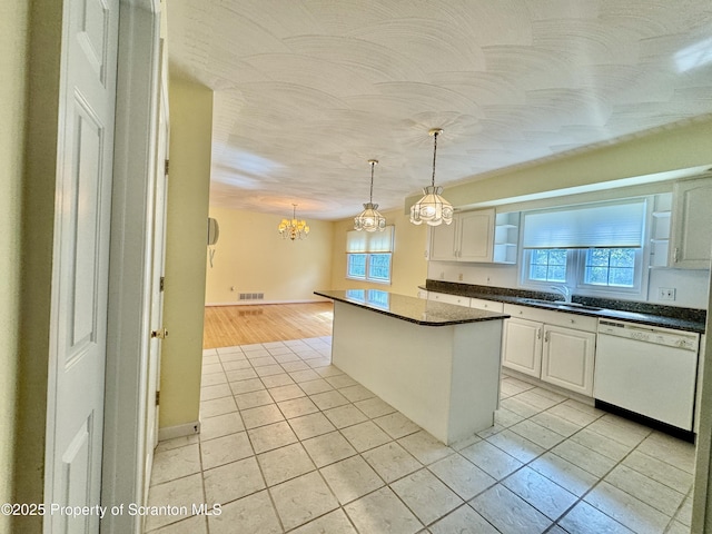 13 Forest Glen Dr, Scranton, PA 18504 - kitchen with white dishwasher, light tile patterned floors, a chandelier, a kitchen island, and white cabinetry