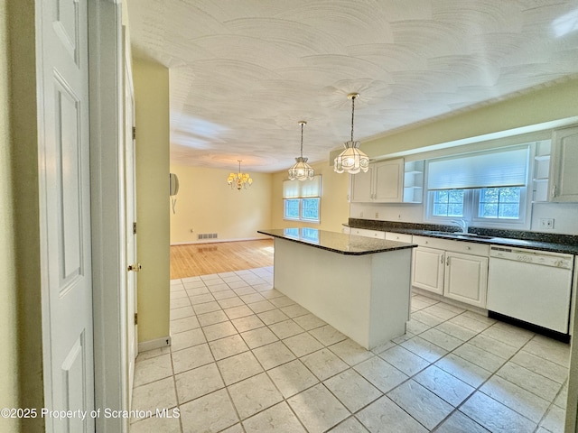 13 Forest Glen Dr, Scranton, PA 18504 - kitchen featuring dishwasher, dark countertops, light tile patterned flooring, a chandelier, and a center island