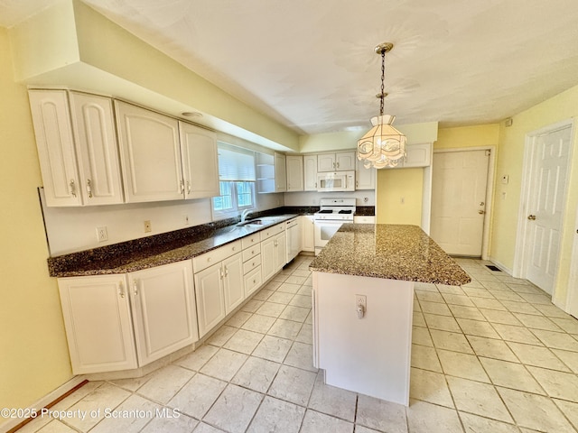 13 Forest Glen Dr, Scranton, PA 18504 - kitchen with white appliances, dark stone counters, decorative light fixtures, and a center island