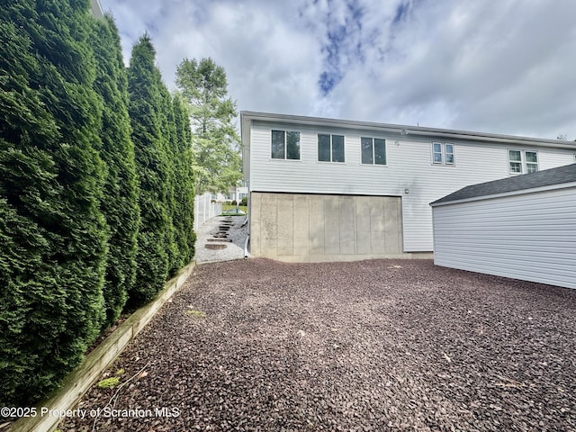 13 Forest Glen Dr, Scranton, PA 18504 - back of house featuring a garage and gravel driveway