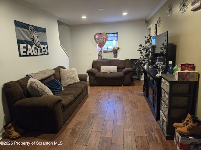 living room with dark hardwood / wood-style floors, cooling unit, and ornamental molding