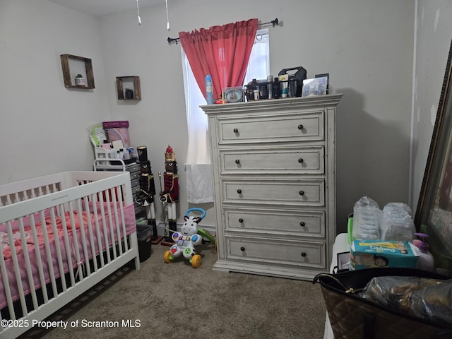 carpeted bedroom with a nursery area